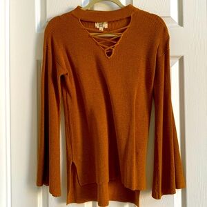 Brown lightweight top. round neck crisscross detail. Bell sleeves hi lo hem